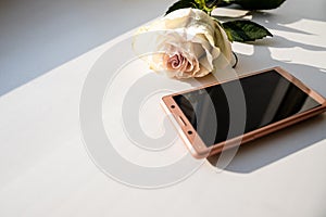 Mobile phone as present for Happy Valentines Day, rose, gift,calendar february 14 on white background, copy space. Card