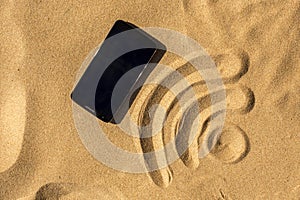 Mobile phone on the beach and WiFi sign