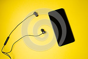 Mobile phone with black headset on a colorful background
