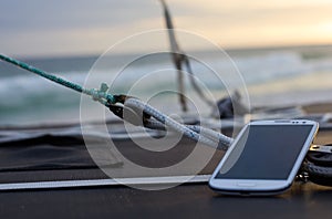 Mobile phone on a boat at sunset