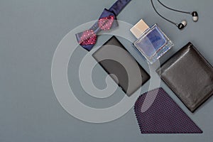 Mobile phone, bow tie, cologne for men, headphones, leather purse and handkerchief