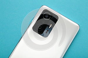 Mobile phone camera, flash lens on blue background