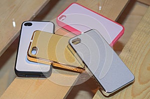 Mobile phone cases on a wood background