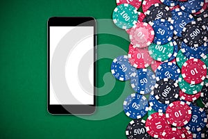 Mobile phone and casino chips on poker table