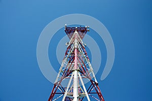 Mobile phone cellular telecommunication radio antenna tower. Cell phone tower against blue sky