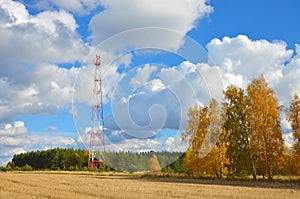 Mobile phone cellular telecommunication radio tv antenna tower against blue sky