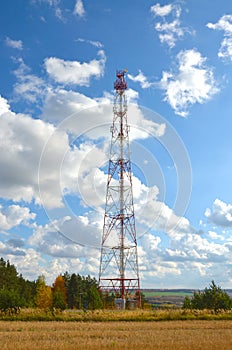 Mobile phone cellular telecommunication radio tv antenna tower against blue sky