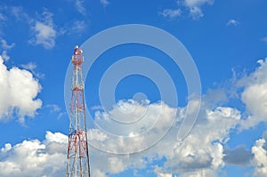 Mobile phone cellular telecommunication radio tv antenna tower against blue sky