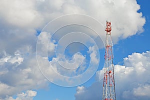 Mobile phone cellular telecommunication radio tv antenna tower against blue sky