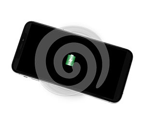 Mobile phone charging with wireless pad isolated on white