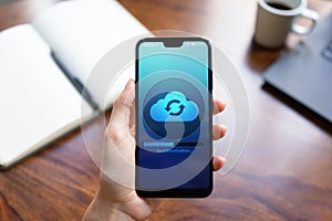 Mobile phone cloud synchronisation process on device screen. Technology concept.