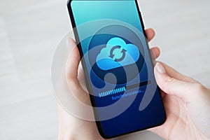 Mobile phone cloud synchronisation process on device screen. Technology concept.