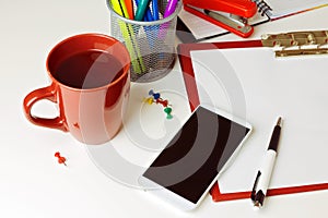 Mobile phone, coffee and office items on white tabletop. Business concept