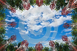Mobile phone communication antenna tower and tree with cloud blu