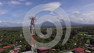 Mobile phone communication celullar radio tower, microwave antenna, transmitter bult within town houses. Drone Aerial