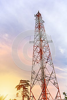 Mobile phone communication and network signal repeater antenna tower with blue sky background. Sun light effect