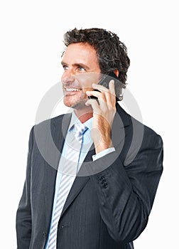 Mobile phone conversation. Handsome mature business man talking on cellphone against white background.