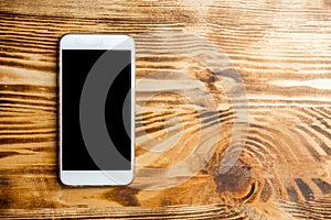 Mobile phone on a dark wooden background