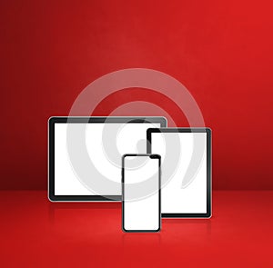 Mobile phone and digital tablet pc on red office desk
