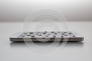 Mobile phone with drops on oleophobic screen.