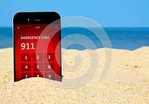 Mobile phone with emergency number 911 on the beach