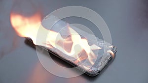 Mobile phone explodes and burns. Cell Phone explosion and fire .Smart Phone Danger from over use or bad manufacturing. Burning up