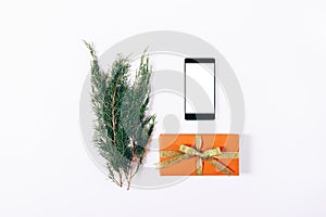 Mobile phone, gift box and coniferous twig