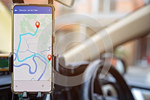 A mobile phone with GPS map navigation in a car