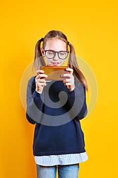 Mobile phone and internet addiction. Little girl with smartphone play mobile game
