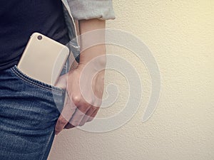 Mobile phone in jeans pocket