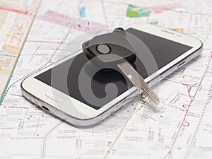 Mobile phone and key car on the map.