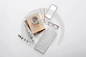 Mobile phone mockup on modern workspace desk. Empty phone screen mock up copy space with computer keyboard and office