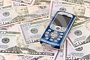 Mobile phone on money background