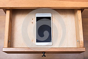 Mobile phone in open drawer