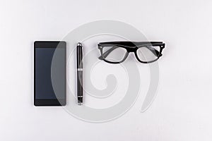 Mobile phone, pen and eyeglasses