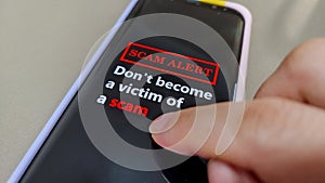 A mobile phone showing the message Don't Become A Victim Of A Scam