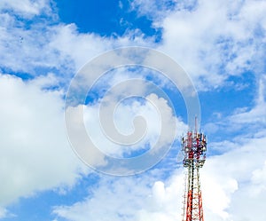 Mobile phone tower and cloudy blue sky