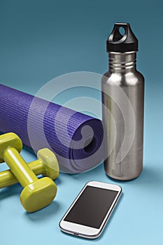 Mobile phone with water bottle and sports equipment