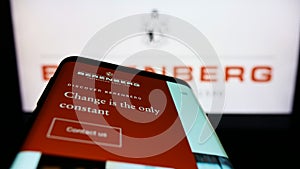 Mobile phone with website of German bank Joh. Berenberg, Gossler Co. KG on screen in front of business logo.