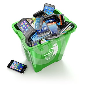 Mobile phones in trash can on white background. Utiliza photo