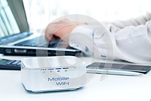 Mobile router device on the table and businessman