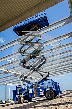 Mobile scaffold, stretched scissor lift platform at construction