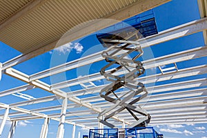 Mobile scaffold, stretched scissor lift platform at construction site