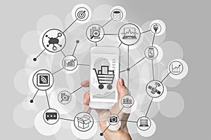 Mobile shopping experience with hand holding smartphone to connect to online shops to purchase consumer goods