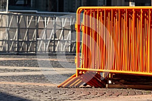 Mobile steel fence. orange street barriers to restrict movement before the concert