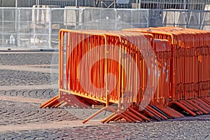 Mobile steel fence. orange street barriers to restrict movement before the concert