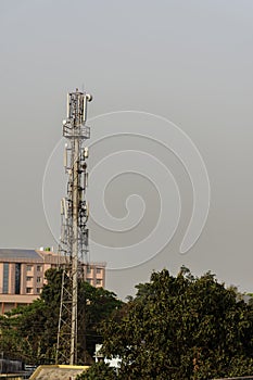 Mobile telecommunication tower antenna and satellite dish with sky background