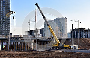 Mobile telescopic boom crane on bridge construction. Truck crane on building bridges. Road work on traffic highway, road