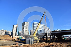 Mobile telescopic boom crane on bridge construction. Truck crane on building bridges. Road work on traffic highway, road