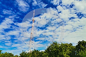 Mobile tower in summer on a background of blue sky